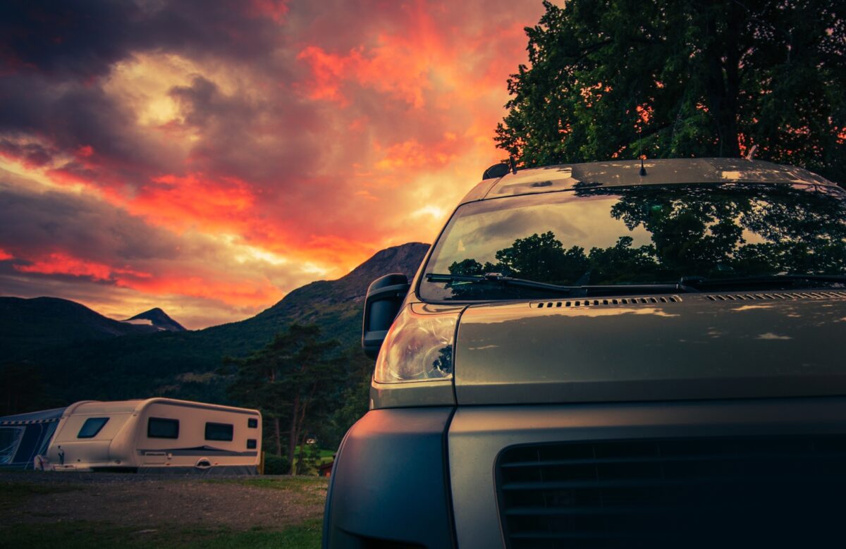 Scenic RV Park Camping During Beautiful Summer Sunset. Motorhome and Travel Trailers in the Background - Texas News, Places, Food, Recreation, and Life.