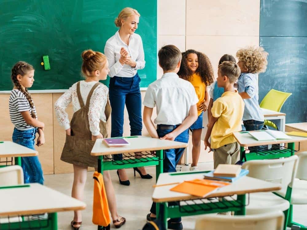 Teacher speaking to students at the front of a class