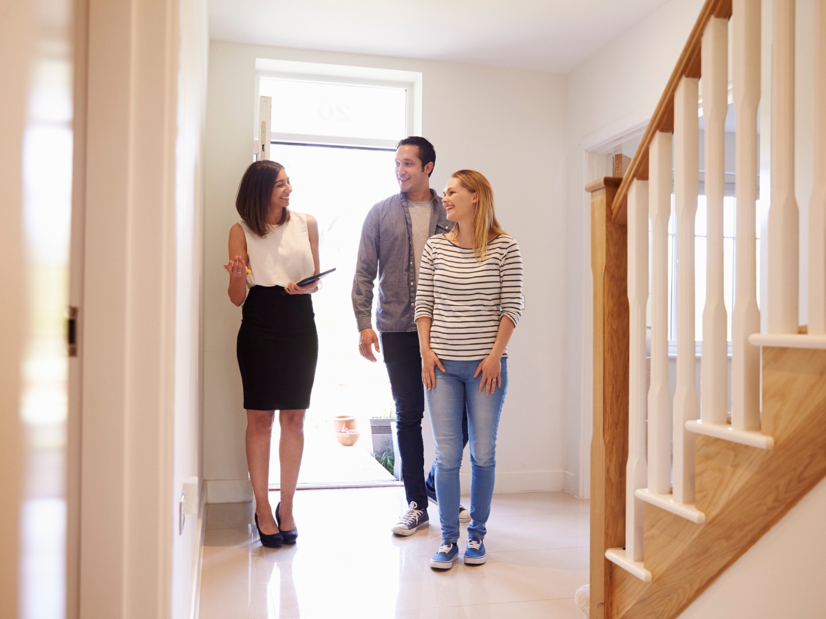 Realtor Showing Young Couple around Property for Sale - Texas View