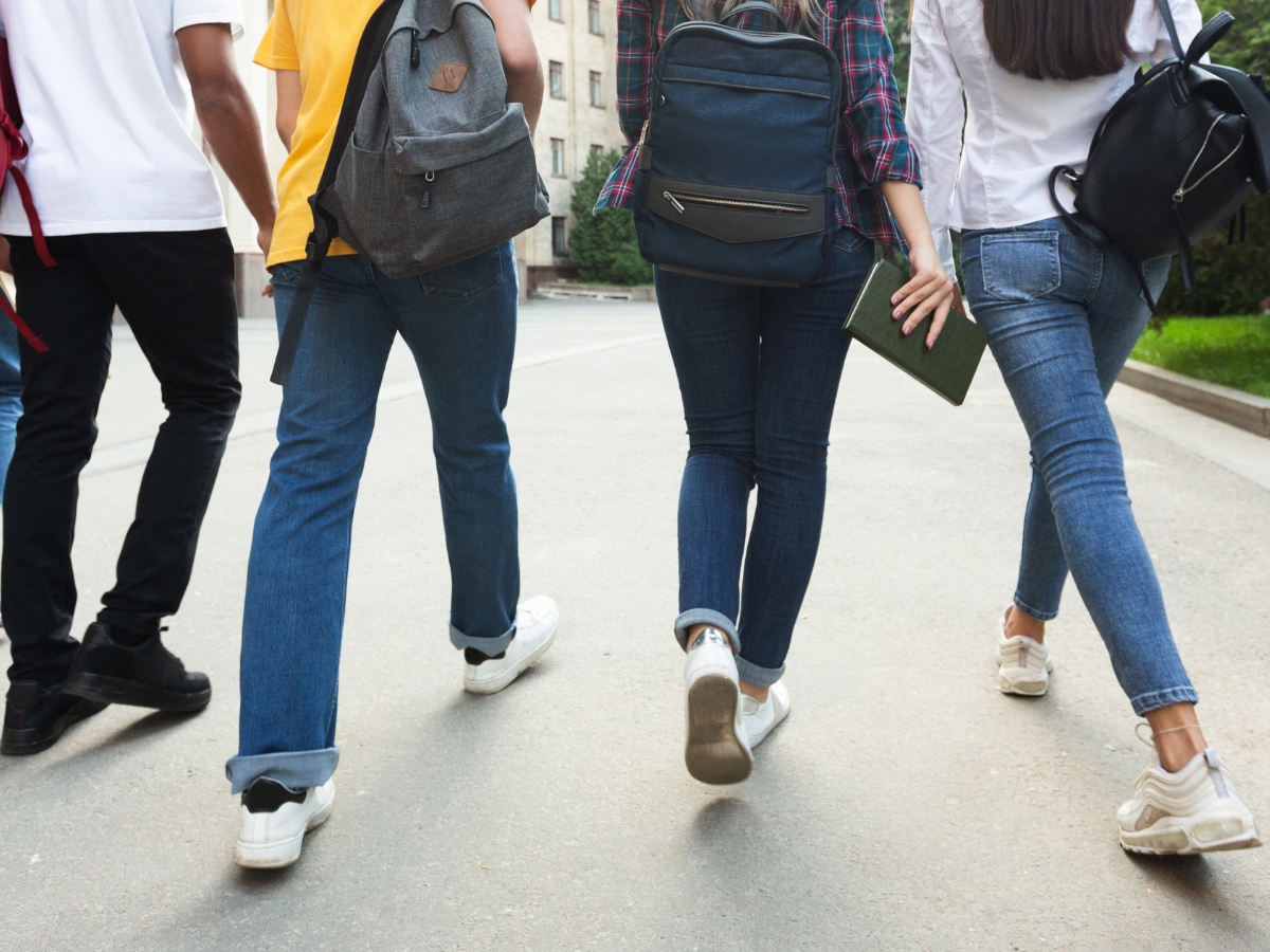 Teenage students walking in a high school campus - Texas News, Places, Food, Recreation, and Life.