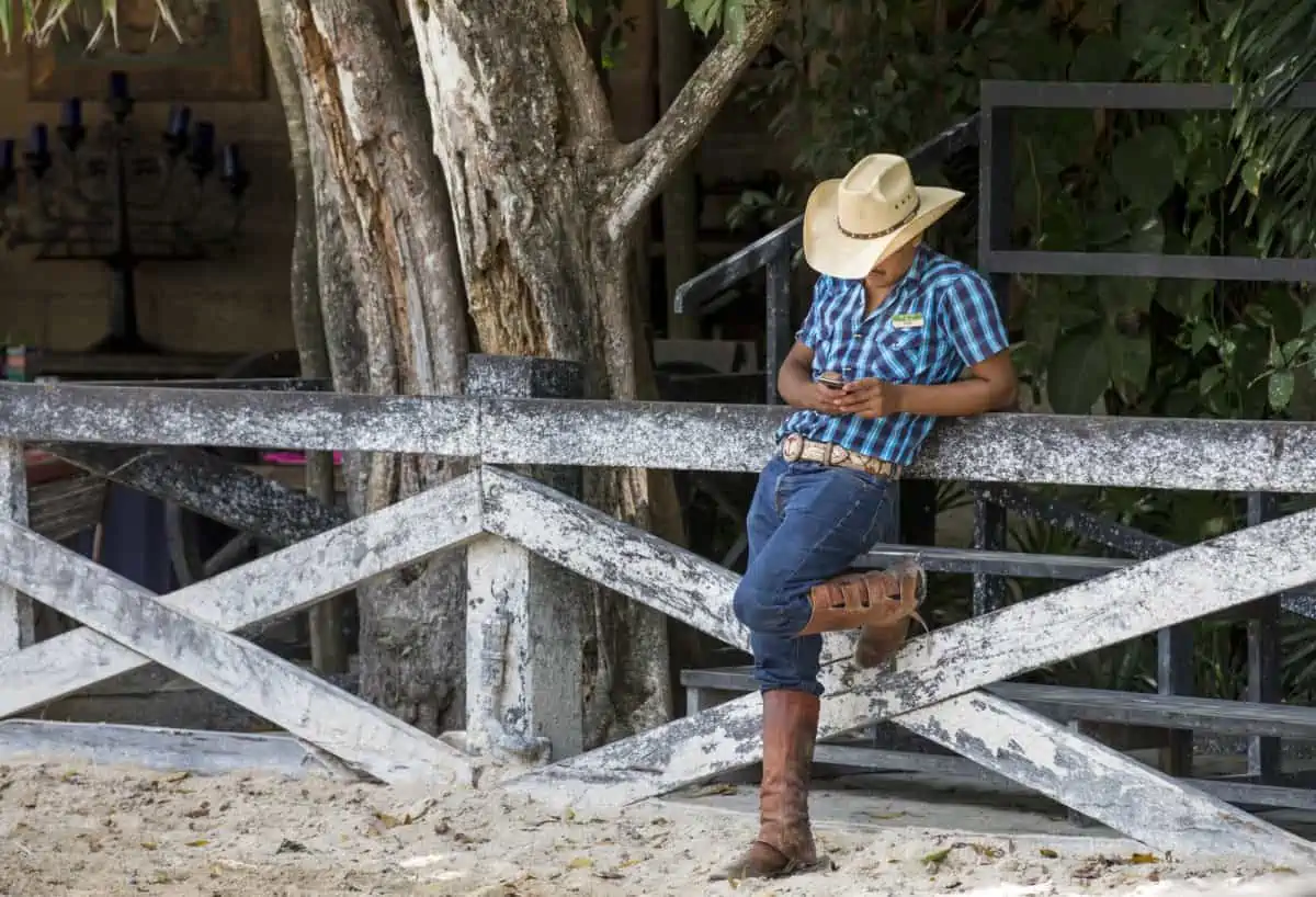 Texas man leaning on a fence at a ranch - Texas View