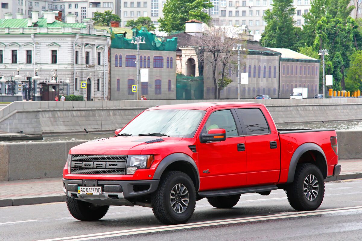 Red pickup truck Ford F 150 Raptor at the city street - Texas View