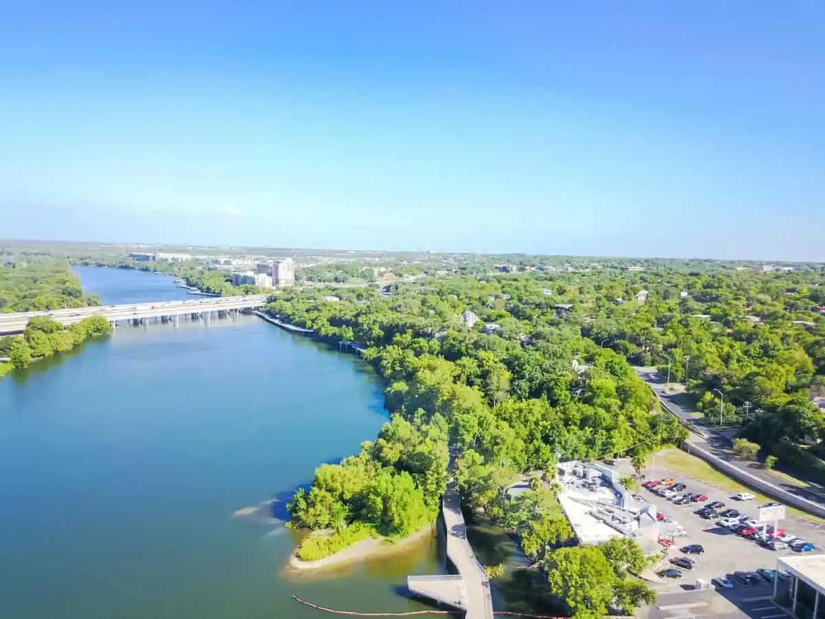 Aerial view Lady Bird Lake and Colorado River near downtown Austin Texas USA. Flyover Austin Boardwalk Ann and Roy Butler hike and bike trail Interregional Highway 35 bridge. - Texas News, Places, Food, Recreation, and Life.