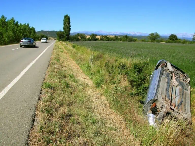 Car crash accident upside down vehicle off the road green. - Texas View