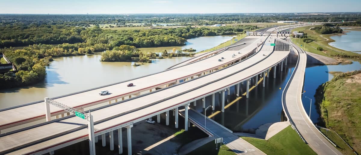 Panorama aerial view elevated highway viaduct through flood area near Dallas Texas USA. Top of multilevel expressway near a lake. - Texas View