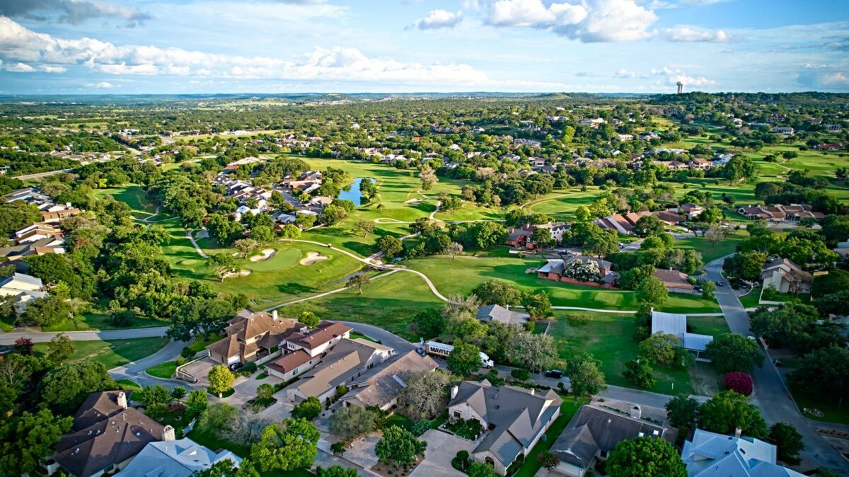 A birds eye view of the surroundings of residential buildings and beautiful green fields. Houston Texas USA. Development of suburban housing construction. - Texas View