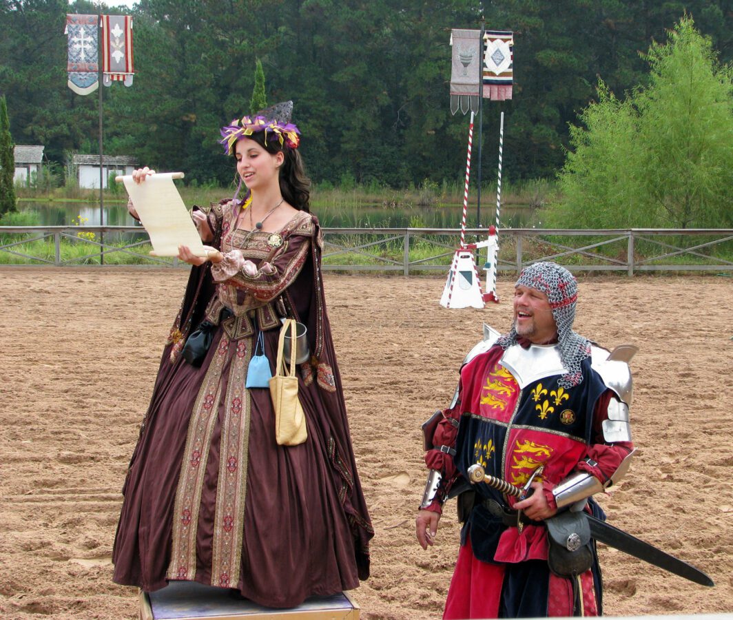 A fair maiden reads a declaration at the Texas Ren Fest Games. - Texas View