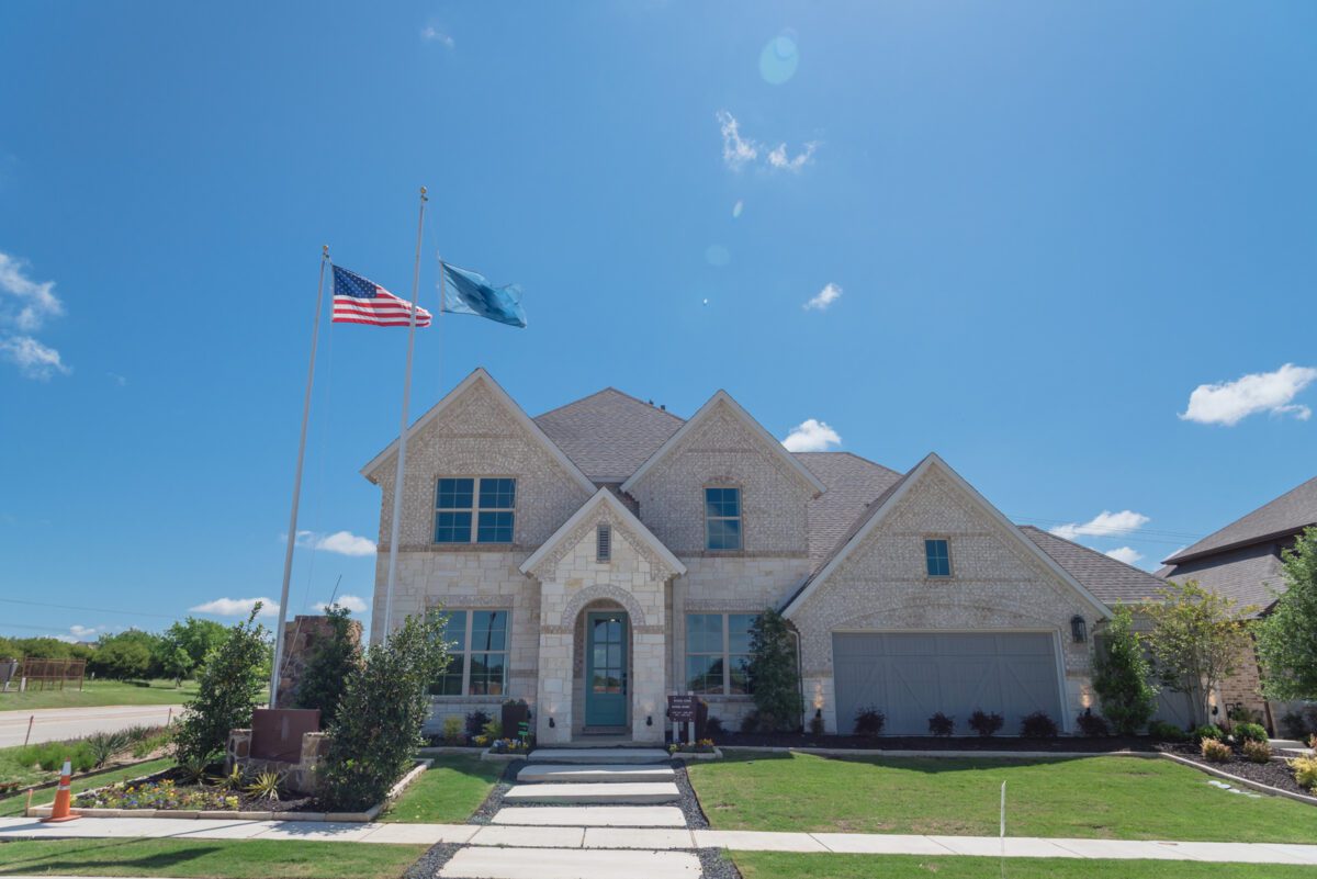 Brand new two story house with attached garage in new development neighborhood near Dallas Texas USA. Model house with American flag. - Texas View