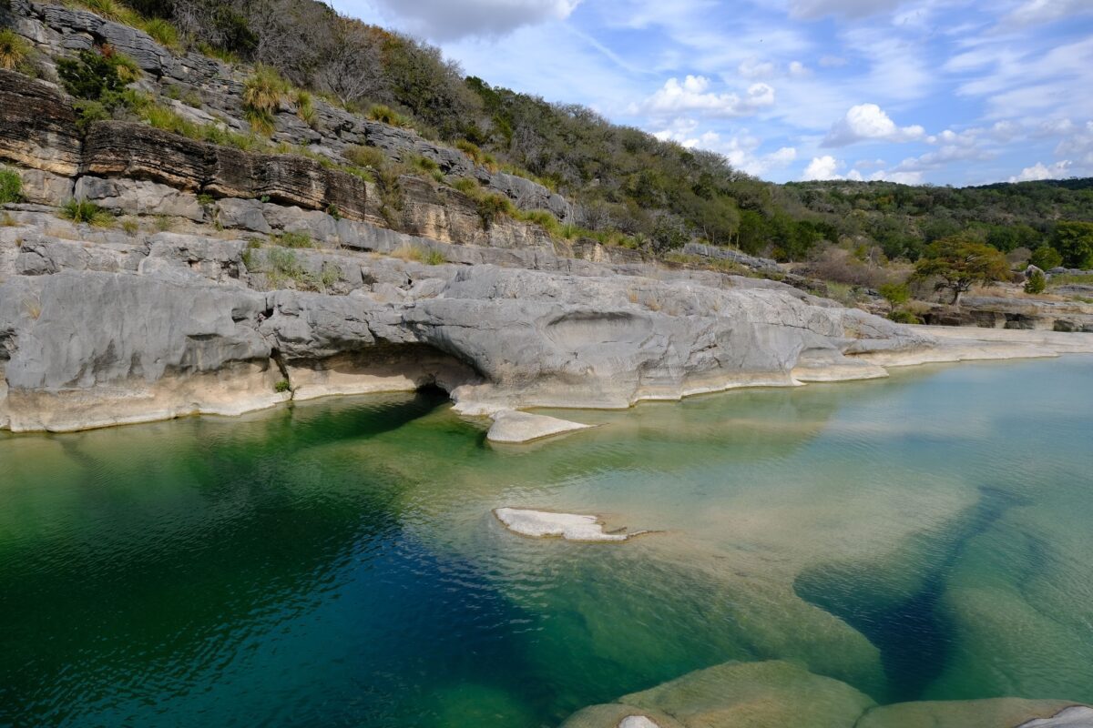 Pedernales Falls State Park under a blue cloudy sky and sunlight in Texas - Texas View