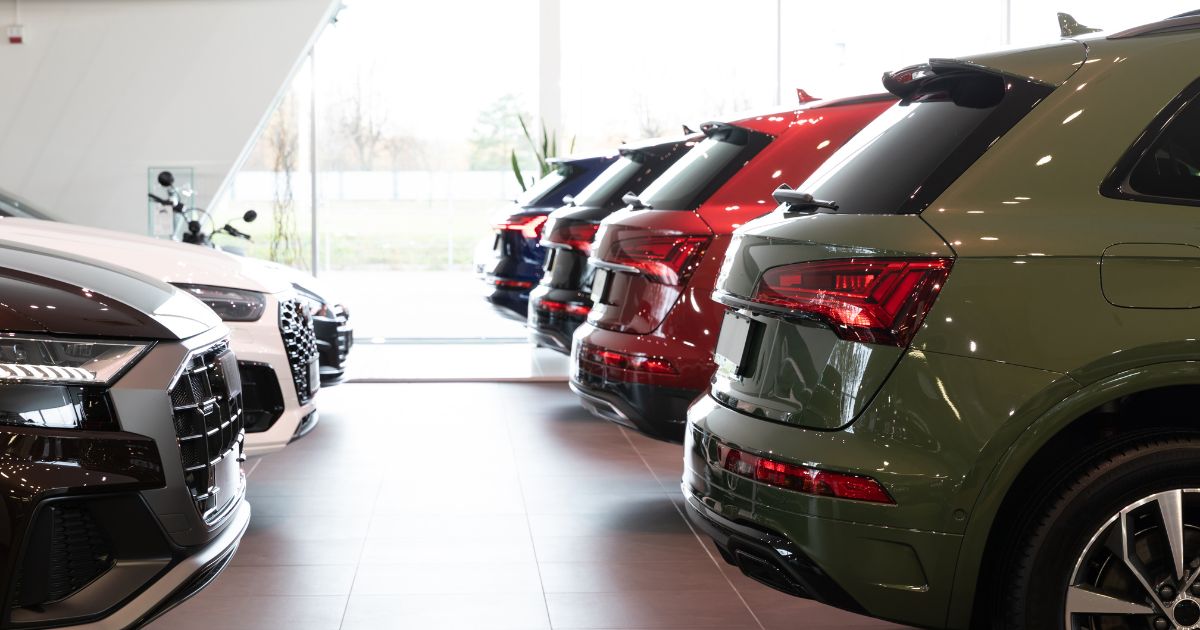 Dealership Car Showroom of Premium SUVs Cars in a Row Rear View - Texas View