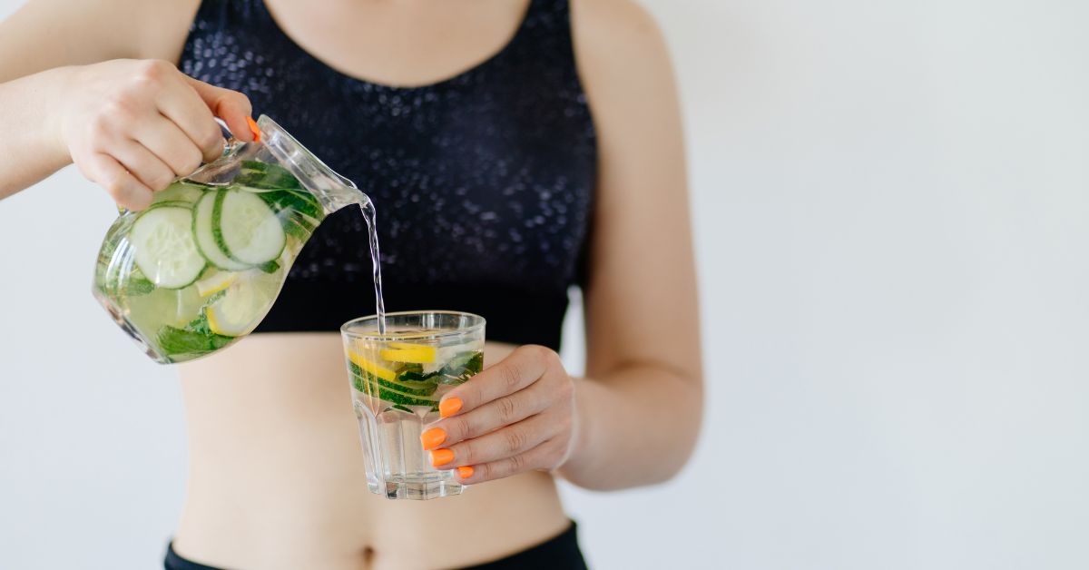 Detox hydration. Fit woman drinking infused water - Texas View