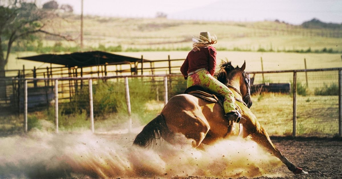 Woman Barrel racing at rodeo - Texas View